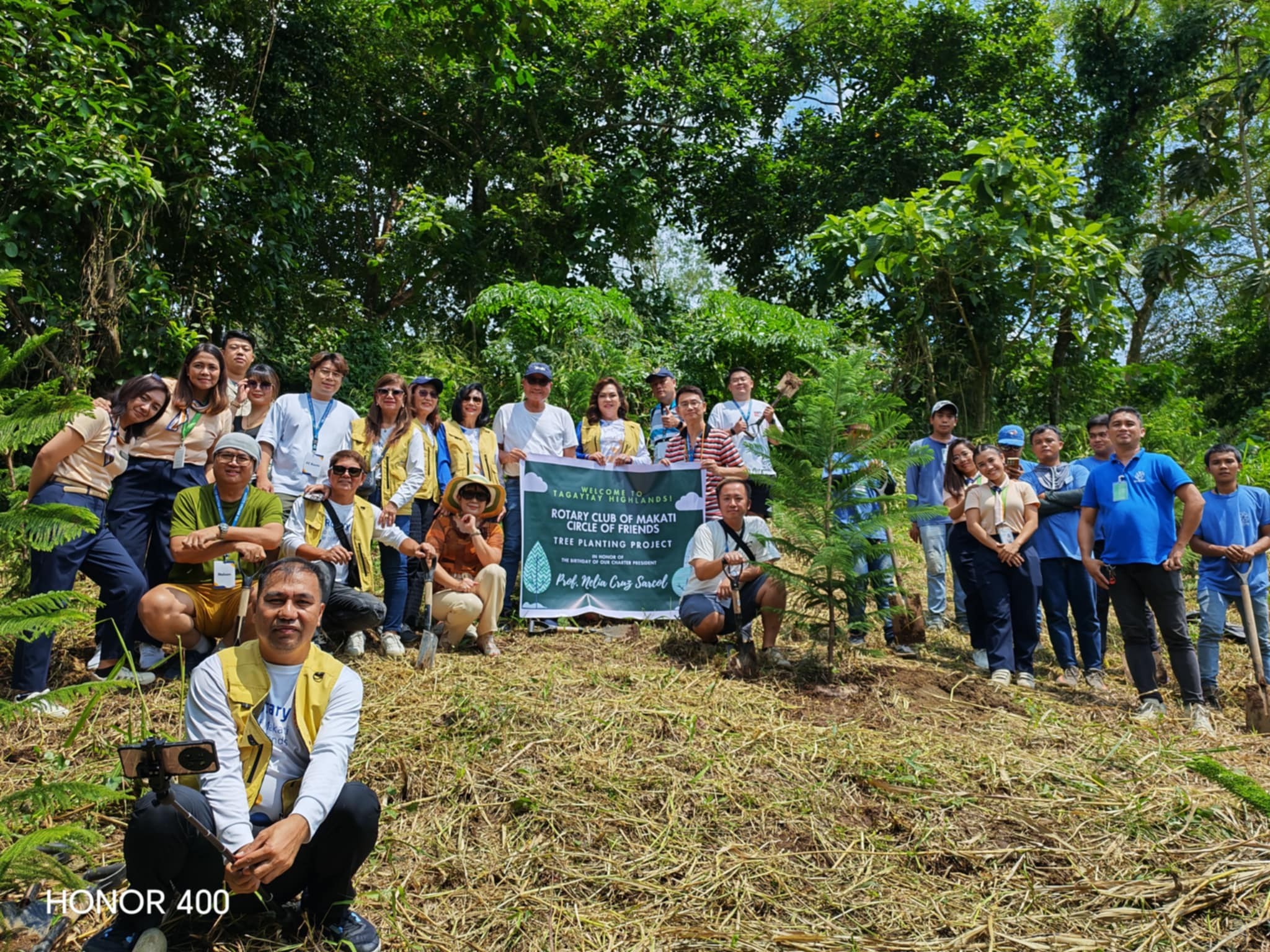 Rotary service field activity with volunteers collaborating, illustrating community engagement and hands-on service.