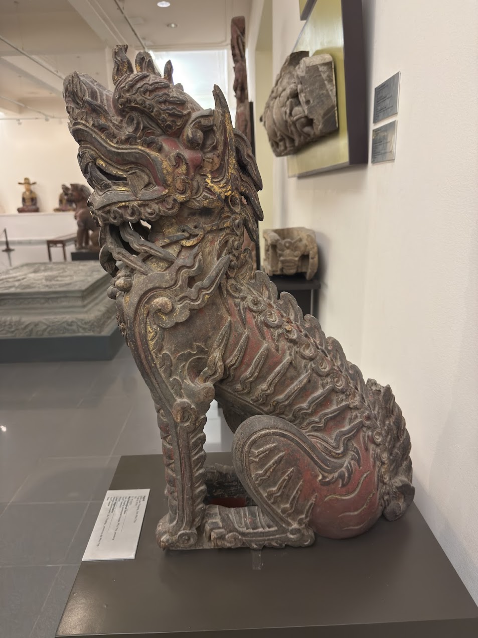 Wood carved Nghê guardian beast displayed in a museum in Hanoi, Vietnam