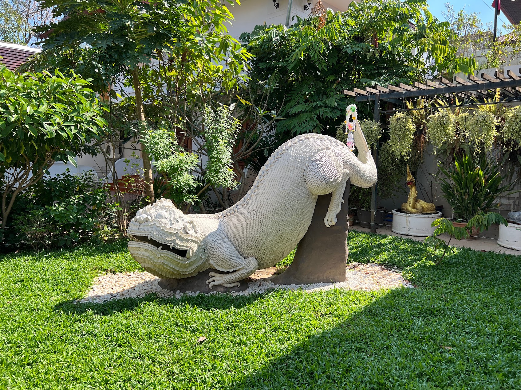 Playful stone lion statue with expressive face in temple setting