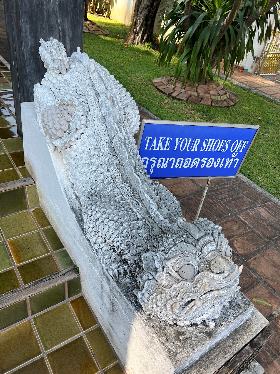 Reclining lion sculpture in Thai temple with elongated body form