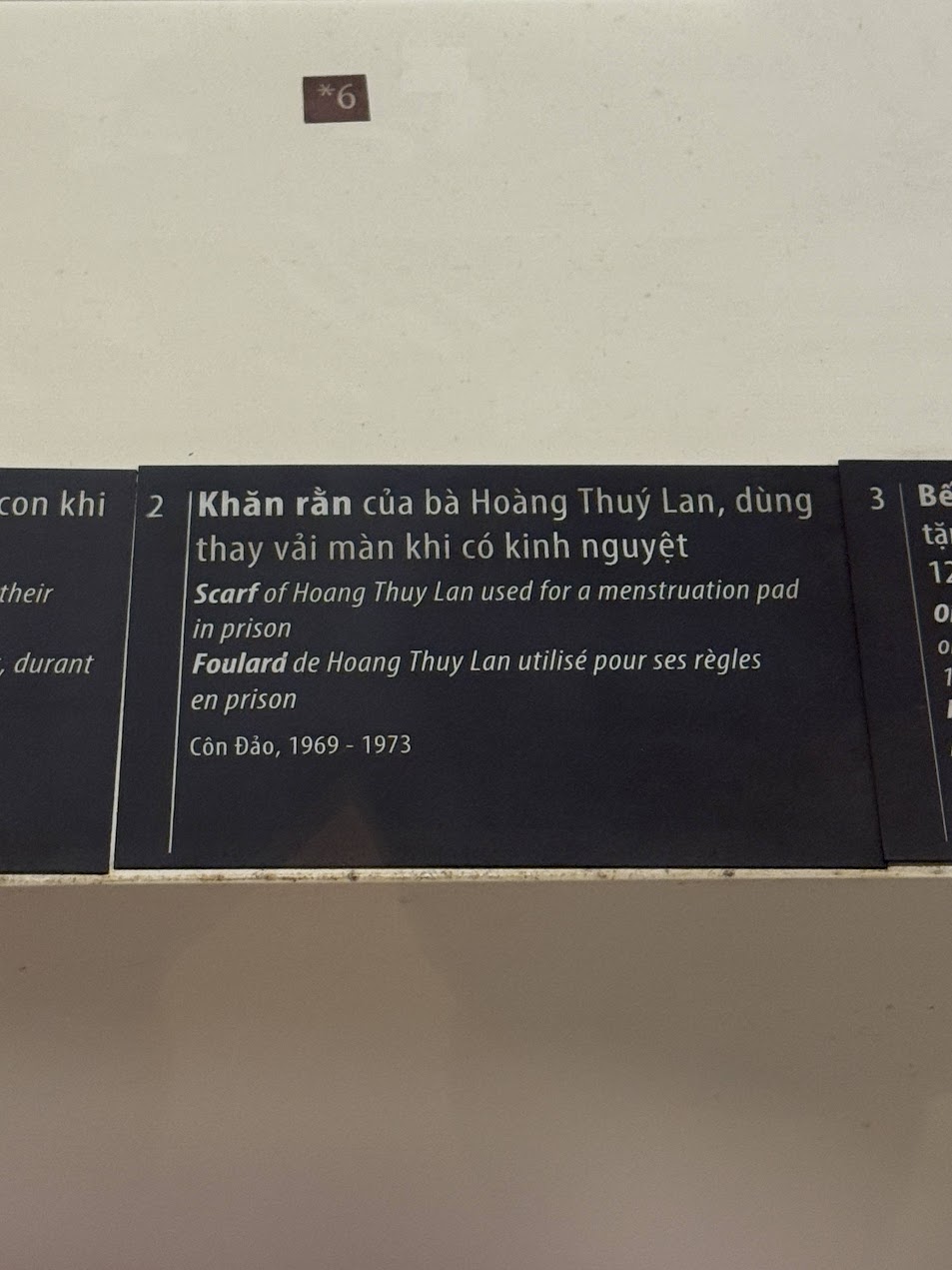 Museum label at Hanoi Women’s Museum explaining that Hoang Thuy Lan’s Khăn Rằn was used as a menstruation pad in prison, Côn Đảo, 1969–1973