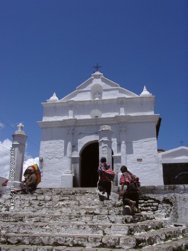 A white church in the Mexican highlands standing between open land and mountain terrain, showing how Catholicism was absorbed into an Indigenous and local sacred landscape.