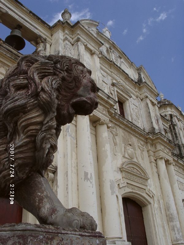 Colonial cathedral facade with lion statue in León, Nicaragua, showing the stony public authority and symbolic force of colonial Catholicism in Latin America.