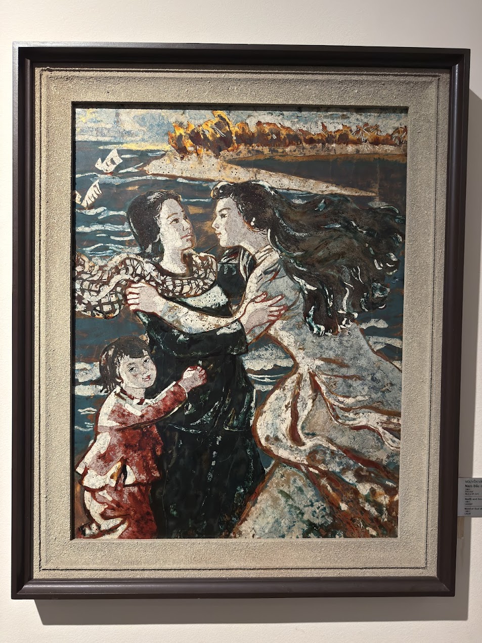 Painting at Vietnam Women’s Museum showing a woman and child in wartime, where fire in the distance and the surrounding seascape create a powerful contrast between war and family survival