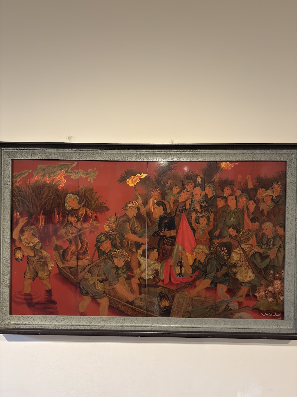 Painting at Vietnam Women’s Museum showing wartime river transport and collective movement, where figures, firelight, and boats together evoke women’s role in wartime transport and mobilisation