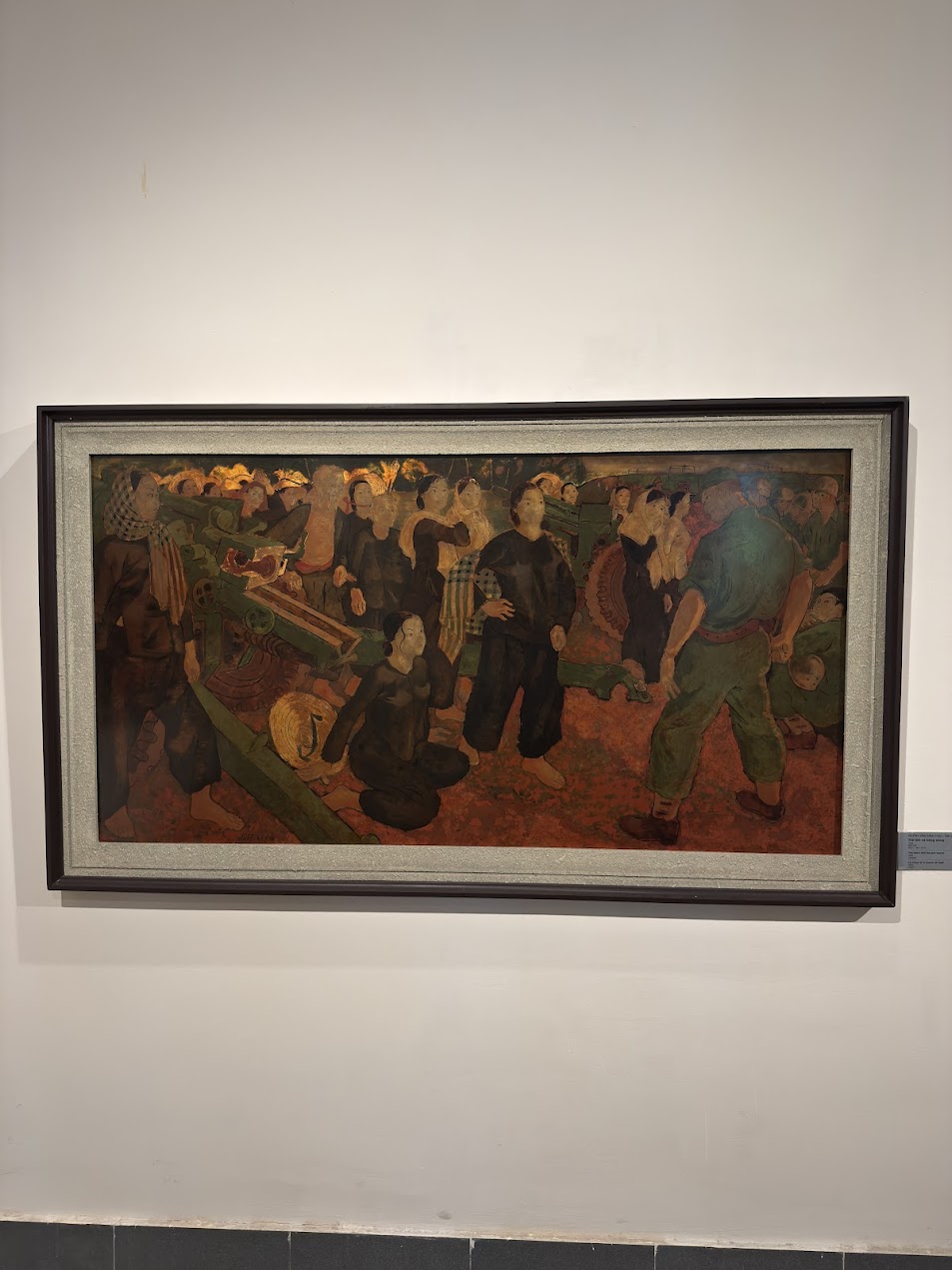 Painting at Vietnam Women’s Museum depicting women alongside artillery equipment in a wartime setting, showing how women were fully built into the structure of combat