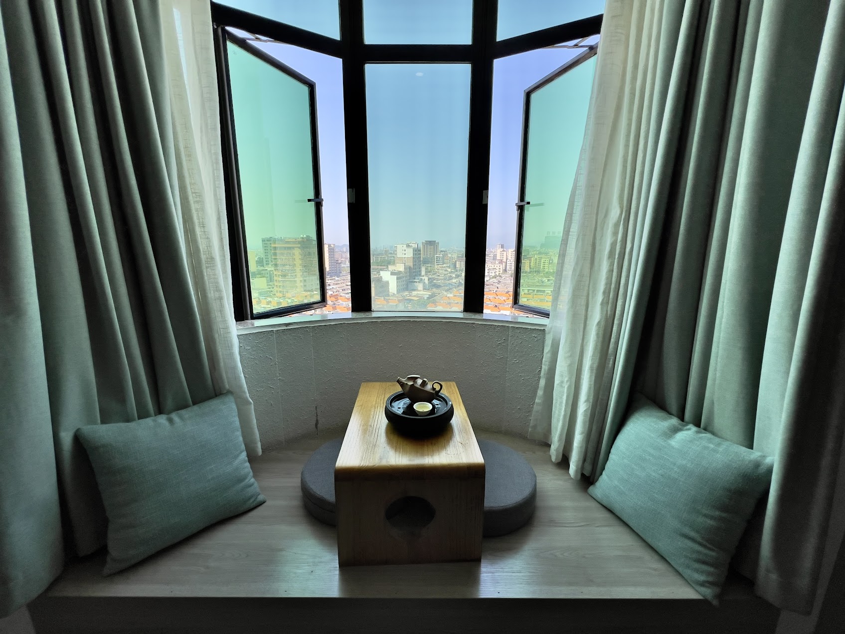 窗邊座位上的旅行茶席與茶具，呈現人在異地停留時以泡茶安定心緒的片刻