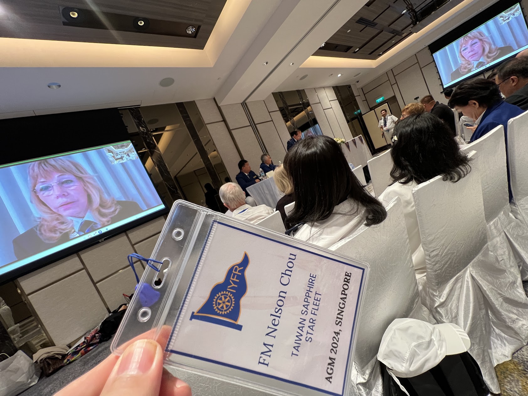 IYFR 國際年會與會識別證特寫,載明 FM Nelson Chou、TAIWAN SAPPHIRE STAR FLEET、AGM 2024, SINGAPORE,並印 IYFR 三角旗標誌