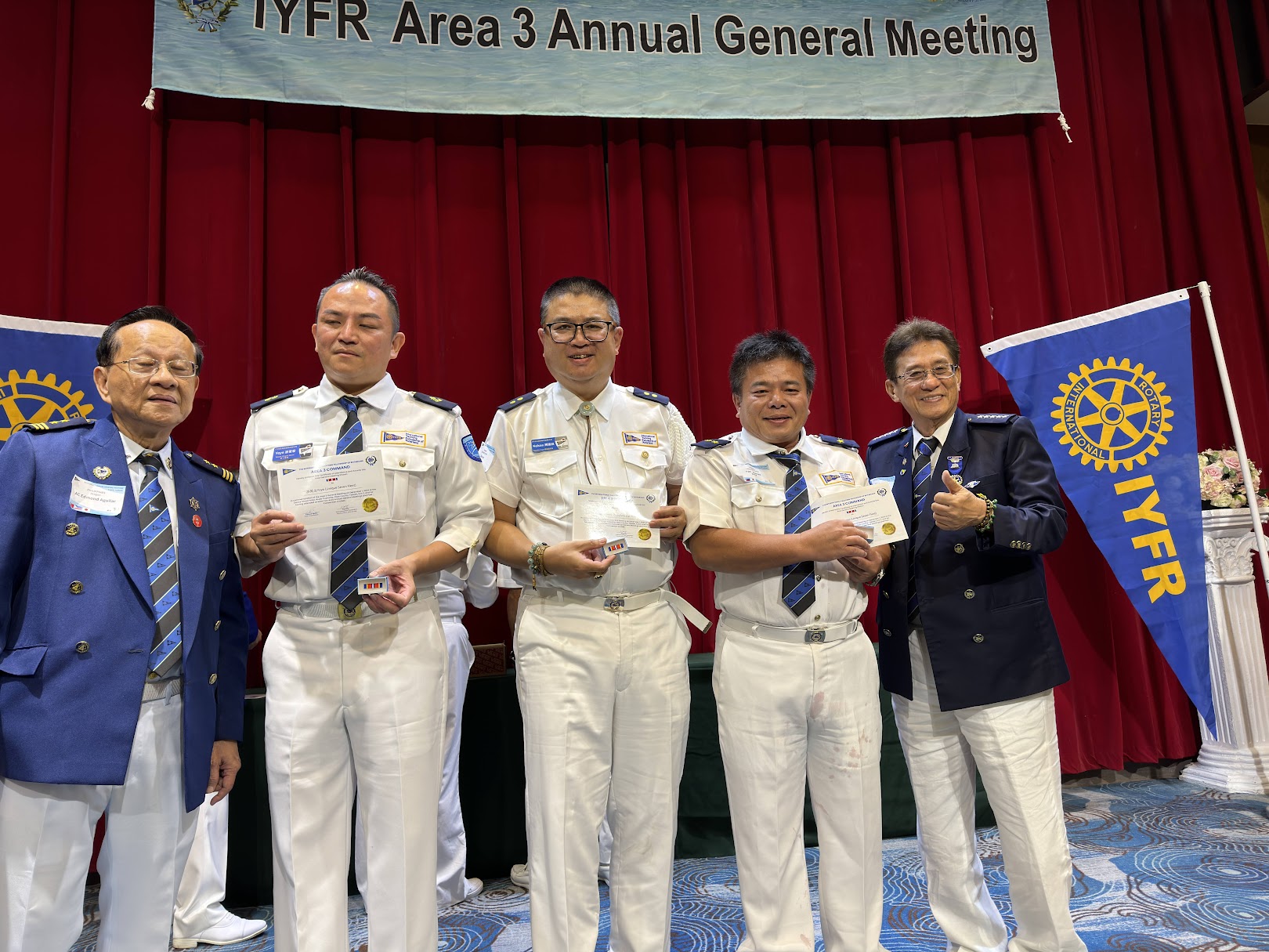 IYFR Area 3 宜蘭 AGM 授證合影，參與者穿著白色制服或深藍外套並佩戴肩章、領帶及識別配件